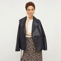 Front image of a woman standing wearing the Alphonso Jacket—Vegan Leather in Black | Lead