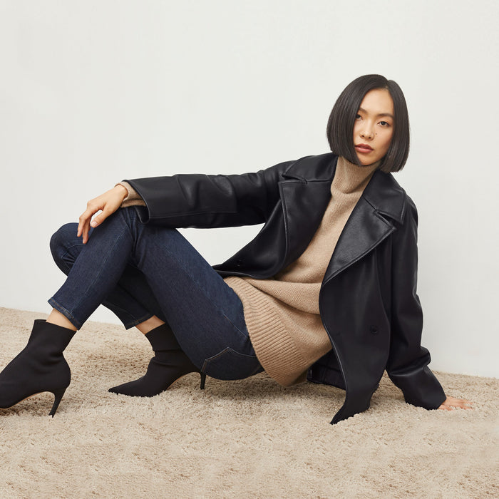 Front image of a woman standing wearing the Alphonso Jacket—Vegan Leather in Black