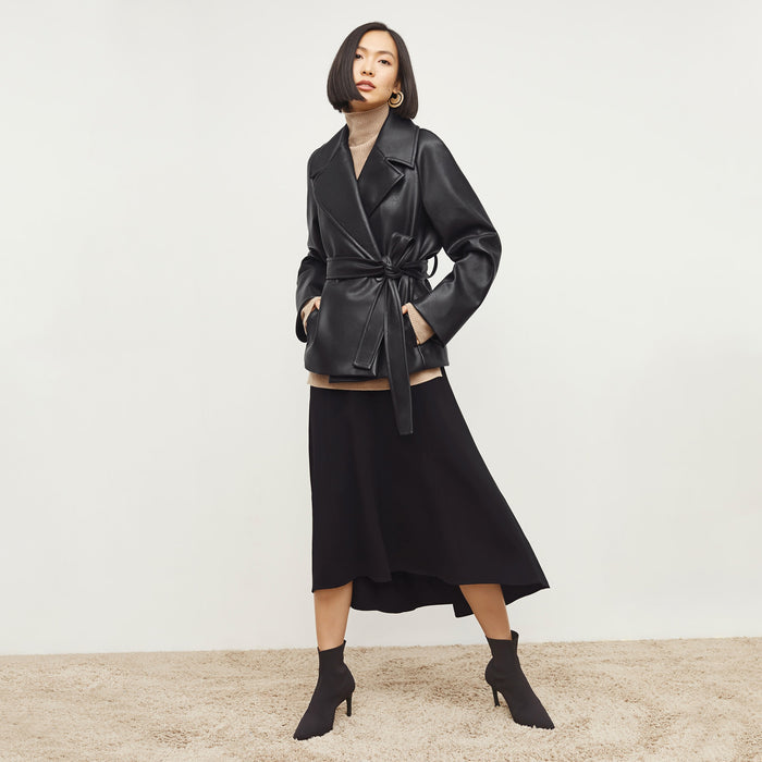 Front image of a woman standing wearing the Alphonso Jacket—Vegan Leather in Black