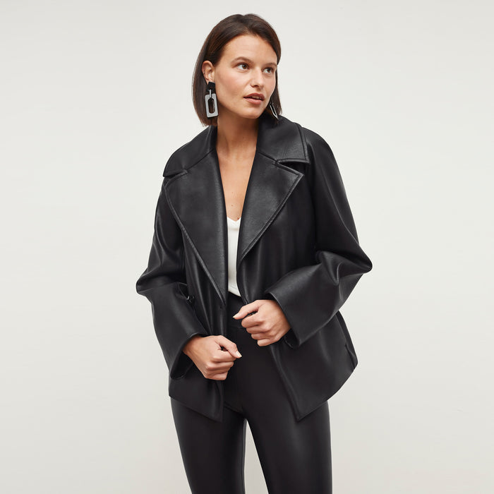 Front image of a woman standing wearing the Alphonso Jacket—Vegan Leather in Black