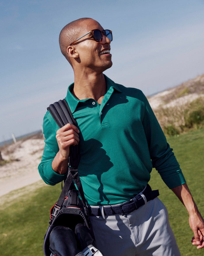 The lifestyle view of the Southern Tide Belfair Performance Long Sleeve Polo by Southern Tide - Fir
