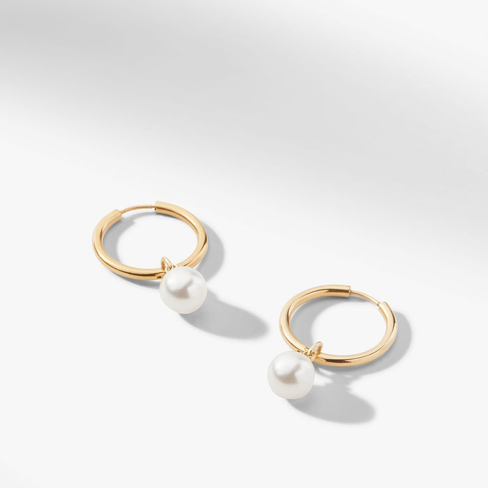 still image of the Claude Charms in Gold on the claressa hoop small in gold | Still