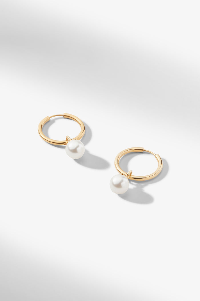 still image of the Claude Charms in Gold on the claressa hoop small in gold | Grid