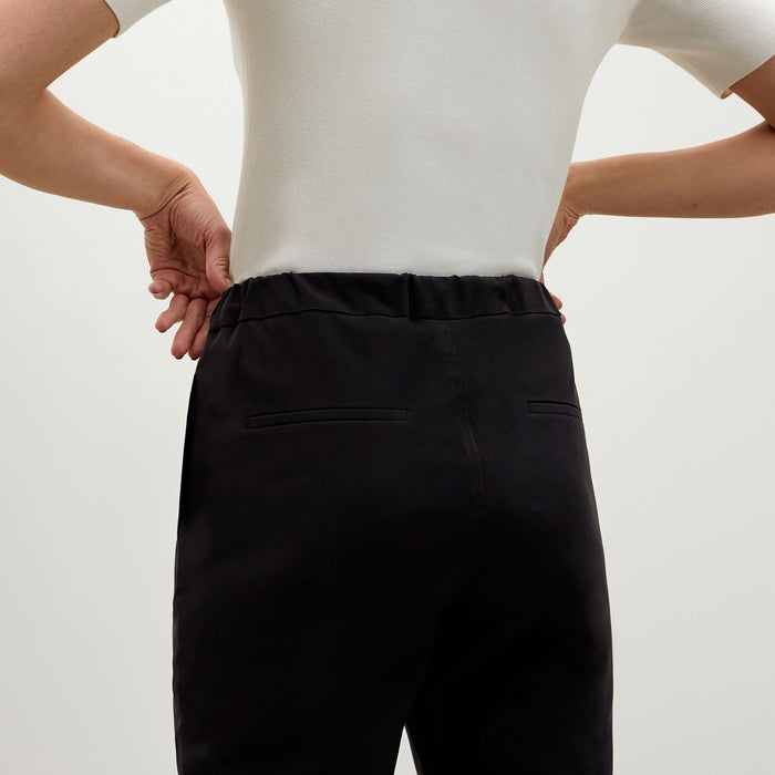 Back image of a woman standing wearing the Colby Jogger in Black | Exclude