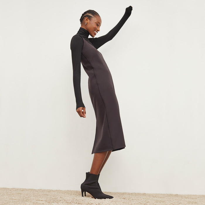 Side image of a woman standing wearing the Elsa Dress—Light Scuba in Haze
