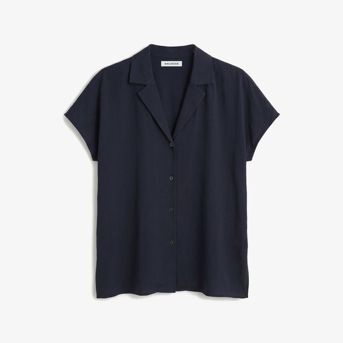 Navy short-sleeve shirt on a light gray background