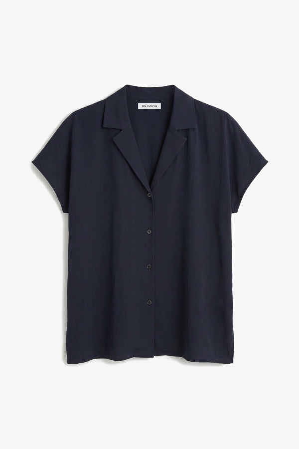 Navy blue shirt on a light gray background. | Still | Exclude