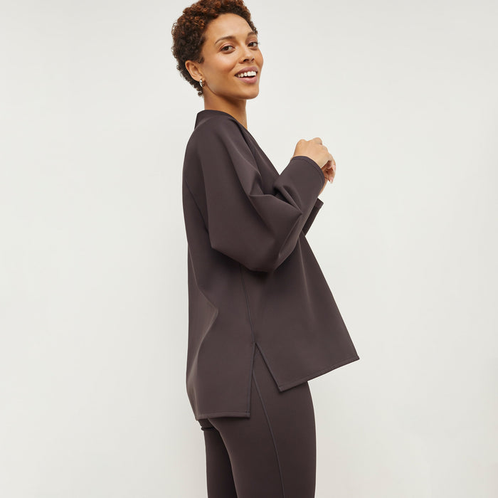 Side image of a woman standing wearing the Harrington Legging—Light Scuba in Haze