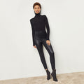 Front image of a woman standing wearing the Harrington Leather—Vegan Leather in Black | Lead