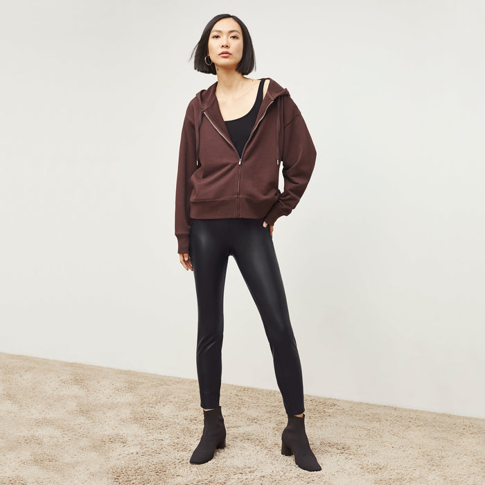 Front image of a woman standing wearing the Harrington Leather—Vegan Leather in Black