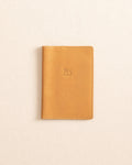The front view of the Il Bisonte Passport Case at Southern Tide - Natural