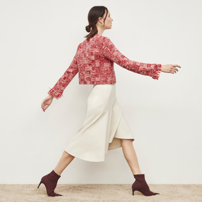 Side image of a woman standing wearing the Lilia Jacket—Interweave in Red Multi