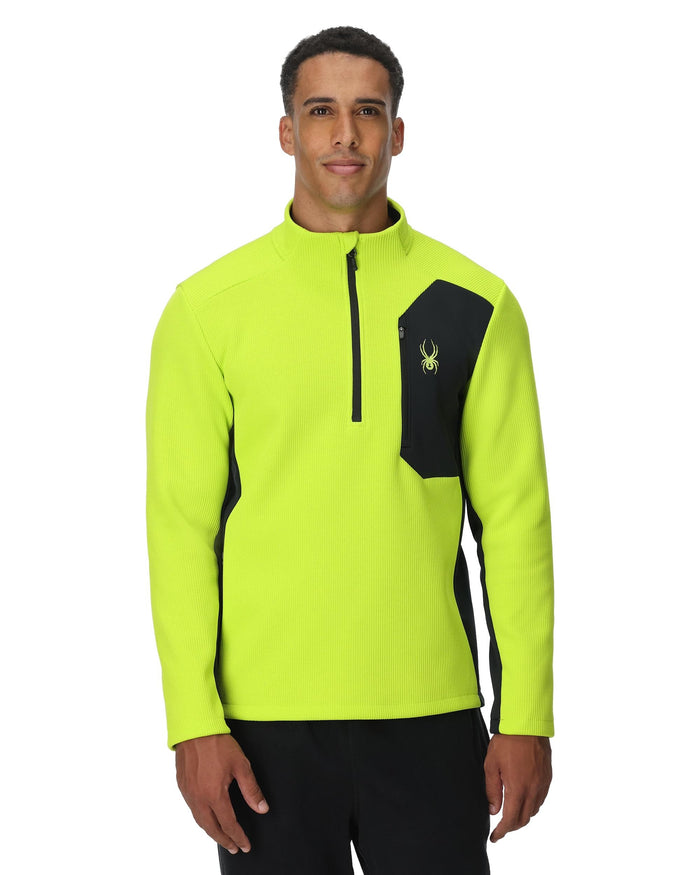 Man wearing a bright yellow and black jacket on a white background