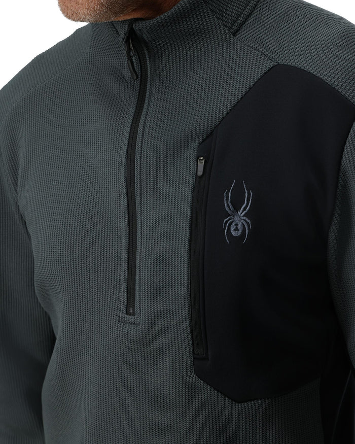 Gray and black jacket with a logo on the chest against a white background