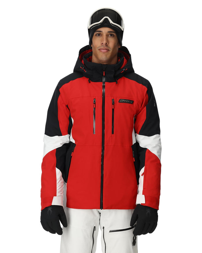 Person wearing a red and black ski jacket with white accents on a white background