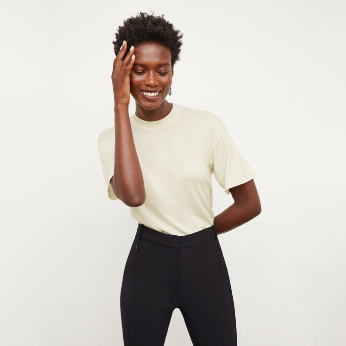Front image of a woman standing wearing the mia top in silk jersey in cream | Lead