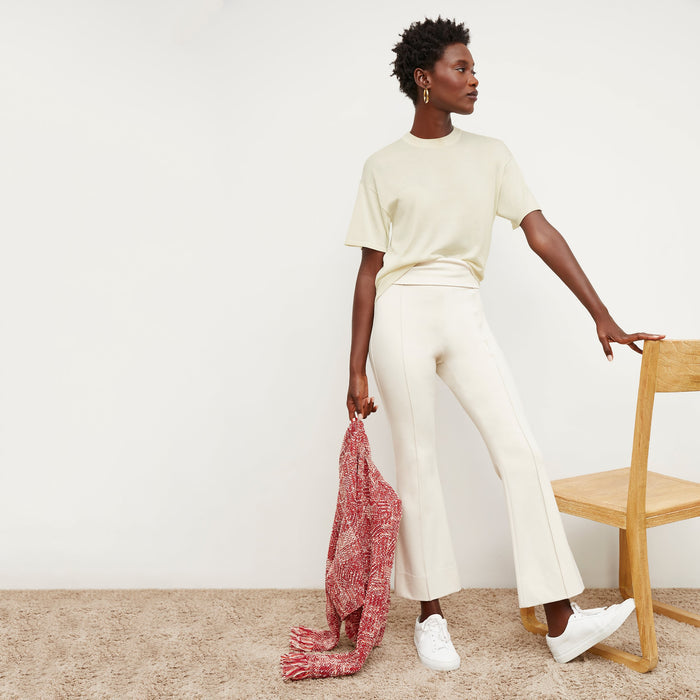 Front image of a woman standing wearing the mia top in silk jersey in cream