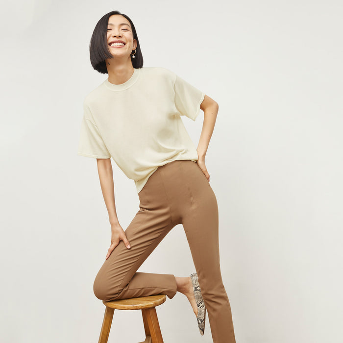 Front image of a woman standing wearing the mia top in silk jersey in cream