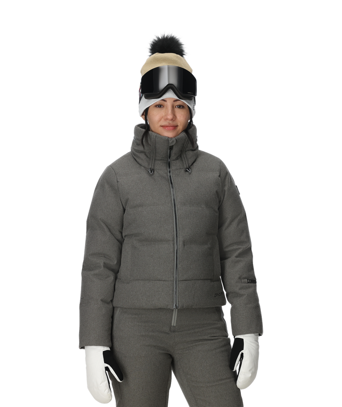 Person wearing a gray winter jacket, pants, gloves, and a beanie with goggles on a white background