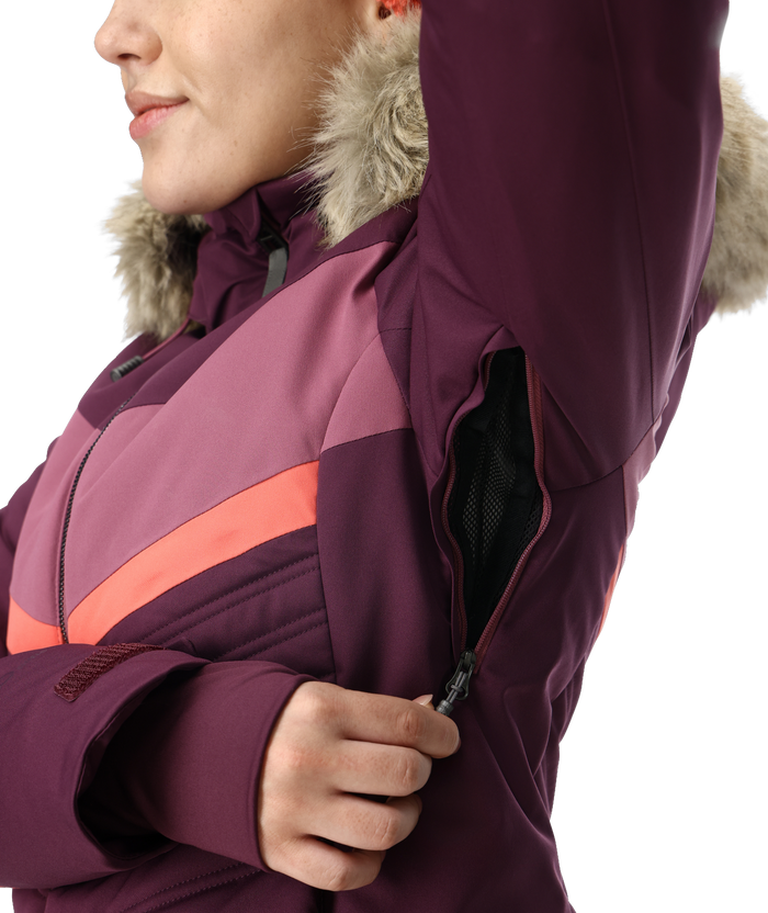 Close-up of a person wearing a purple winter jacket with fur hood on a white background